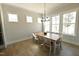 Sunlit dining room featuring hardwood floors and large windows at 14 Duck Bill Trl, Pittsboro, NC 27312