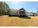 Back exterior of home with screened-in porch and landscaping at 14 Duck Bill Trl, Pittsboro, NC 27312