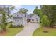 Attractive craftsman style home with large driveway, three-car garage, and well-manicured lawn at 14 Duck Bill Trl, Pittsboro, NC 27312
