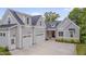Attractive craftsman-style home with three-car garage, grey siding and a dark shingle roof at 14 Duck Bill Trl, Pittsboro, NC 27312