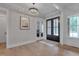 Open foyer with a modern chandelier and an attractive view of the front entry doors at 14 Duck Bill Trl, Pittsboro, NC 27312