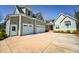 Charming two-story home featuring a three-car garage, craftsman details, and manicured landscaping at 14 Duck Bill Trl, Pittsboro, NC 27312