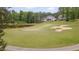 Lush golf course view with serene pond and expertly designed sand traps, perfect for leisure and recreation at 14 Duck Bill Trl, Pittsboro, NC 27312