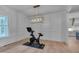 Modern home gym with hardwood floors, board and batten walls, and a modern light fixture at 14 Duck Bill Trl, Pittsboro, NC 27312