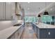 A modern kitchen with white cabinets, a large island, and stainless steel appliances at 14 Duck Bill Trl, Pittsboro, NC 27312