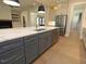 Modern kitchen with stainless appliances, custom cabinets, and large island with quartz countertop at 14 Duck Bill Trl, Pittsboro, NC 27312