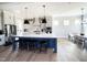 Gourmet kitchen boasts a large island, stainless steel appliances, and custom pendant lighting at 14 Duck Bill Trl, Pittsboro, NC 27312