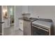 Laundry room with modern washer and dryer, sink, and cabinets at 14 Duck Bill Trl, Pittsboro, NC 27312
