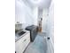 Well-equipped laundry room with gray tile floor, washer, dryer, sink and storage at 14 Duck Bill Trl, Pittsboro, NC 27312