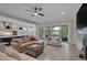 Spacious living room with a large sofa, a kitchen, and a sliding glass door at 14 Duck Bill Trl, Pittsboro, NC 27312