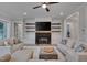 Bright living room features a fireplace, mounted TV, hardwood floors, and comfortable furniture at 14 Duck Bill Trl, Pittsboro, NC 27312