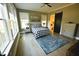 Comfortable main bedroom featuring light hardwood floors, a ceiling fan and lots of light at 14 Duck Bill Trl, Pittsboro, NC 27312