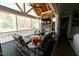 Screened porch with fireplace, ceiling fan, and outdoor seating area at 14 Duck Bill Trl, Pittsboro, NC 27312