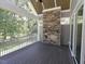 Enjoy the outdoors in this screened porch with a stone fireplace and wooded view at 14 Duck Bill Trl, Pittsboro, NC 27312