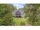 View of backyard screened porch, nestled among the trees, offers serene outdoor living at 14 Duck Bill Trl, Pittsboro, NC 27312