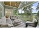 Relaxing screened-in porch with comfortable seating and a great view of the manicured backyard at 14 Duck Bill Trl, Pittsboro, NC 27312