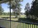 Screened-in porch view of a golf course and pond at 14 Duck Bill Trl, Pittsboro, NC 27312
