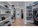 Bright walk-in closet with custom white shelving and hardwood floors at 14 Duck Bill Trl, Pittsboro, NC 27312