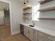 Elegant wet bar featuring floating shelves, a wine fridge, and a sink at 14 Duck Bill Trl, Pittsboro, NC 27312