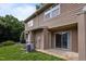 Exterior view of the backyard with sliding glass doors and grass surrounded by woods at 145 Coleridge Ct, Carrboro, NC 27510
