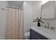 Modern bathroom features a blue vanity, marble countertop, gold hardware, and stylish shower curtain at 145 Coleridge Ct, Carrboro, NC 27510