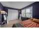 Bright bedroom with wood flooring featuring a dresser with large windows for plentiful light at 145 Coleridge Ct, Carrboro, NC 27510