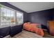 Bedroom featuring windows to provide natural light and wood flooring and a navy wall at 145 Coleridge Ct, Carrboro, NC 27510