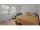 Bright bedroom featuring a cozy bed with wooden desk near the window and wood flooring at 145 Coleridge Ct, Carrboro, NC 27510