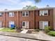 Charming brick townhomes with well-maintained landscaping and purple shutters provide a cozy curb appeal at 145 Coleridge Ct, Carrboro, NC 27510