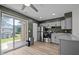 The kitchen features stainless appliances, modern cabinets, and an open layout with a sliding door to the patio at 145 Coleridge Ct, Carrboro, NC 27510