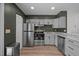 Modern kitchen with stainless appliances, granite countertops, and sleek cabinets at 145 Coleridge Ct, Carrboro, NC 27510