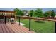 Wood deck with black rails, white flowers, and a view of backyard and surrounding neighborhood at 2020 Cotton Barn Ct, Wendell, NC 27591