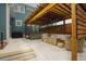 An inviting back patio with a pergola, hot tub, and comfortable seating, ideal for outdoor relaxation at 2020 Cotton Barn Ct, Wendell, NC 27591