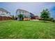 Large, well-manicured backyard with a patio, deck, and ample green space for outdoor activities at 2020 Cotton Barn Ct, Wendell, NC 27591
