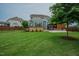 Spacious backyard featuring a deck, a covered patio, lush green lawn, and mature trees for shade and privacy at 2020 Cotton Barn Ct, Wendell, NC 27591