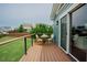 Deck with table and chairs overlooks the fenced backyard and green space at 2020 Cotton Barn Ct, Wendell, NC 27591