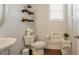 Half bath featuring modern fixtures, decorative shelves, and neutral paint at 2020 Cotton Barn Ct, Wendell, NC 27591