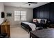 Stylist bedroom featuring a black accent wall, ceiling fan, and natural wood dresser at 2020 Cotton Barn Ct, Wendell, NC 27591