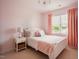 Charming bedroom with a decorative chandelier, a comfortable bed, and pink walls and accents at 2020 Cotton Barn Ct, Wendell, NC 27591