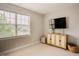 Bright and spacious room featuring a large window, a TV, and a modern cabinet at 2020 Cotton Barn Ct, Wendell, NC 27591
