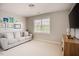 Inviting room with a comfortable sofa and a mounted TV, perfect for relaxation and entertainment at 2020 Cotton Barn Ct, Wendell, NC 27591