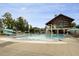 Community pool with a splash area and a slide, surrounded by lounge chairs at 2020 Cotton Barn Ct, Wendell, NC 27591