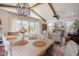 Open-concept dining area with hardwood floors, exposed beam ceiling and access to outside deck at 2020 Cotton Barn Ct, Wendell, NC 27591