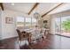 Dining room with vaulted ceilings, wood beams, and an access door to the deck at 2020 Cotton Barn Ct, Wendell, NC 27591