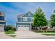 Charming blue two-story home with a well-manicured lawn, and a two car garage at 2020 Cotton Barn Ct, Wendell, NC 27591