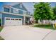 Charming blue home with a two-car garage and landscaped front yard at 2020 Cotton Barn Ct, Wendell, NC 27591