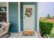 Charming front door with a floral wreath and a welcoming door mat at 2020 Cotton Barn Ct, Wendell, NC 27591