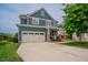 Beautiful two-story home featuring a two-car garage, brick-accented porch, and well-manicured lawn at 2020 Cotton Barn Ct, Wendell, NC 27591