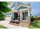 Inviting front porch with white pillars, comfortable seating, and patriotic decor at 2020 Cotton Barn Ct, Wendell, NC 27591