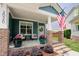Charming front porch with teal siding, white trim, and patriotic American flag at 2020 Cotton Barn Ct, Wendell, NC 27591